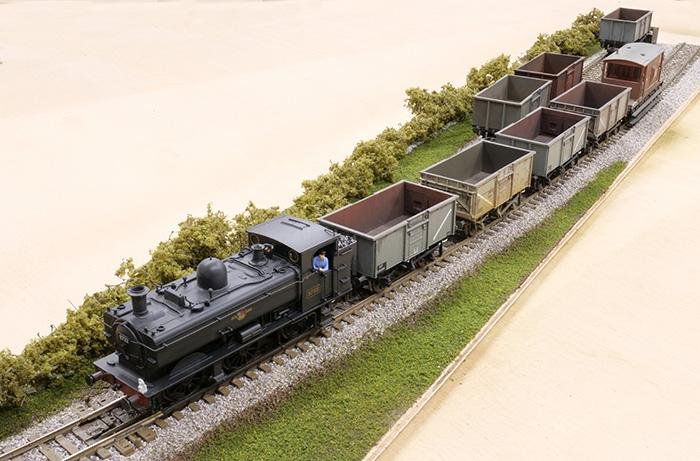 The finished scene is a complete diorama featuring a main line and siding. Finishing touches include light weathering with diluted Geoscenics Black Concentrate to take away the fresh appearance of the ballast plus Woodland Scenics fine leaf foliage across the rear of the scene.