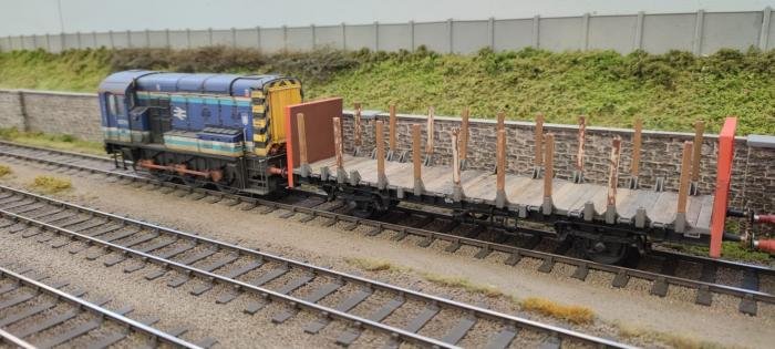 A repainted Dapol Class 08 shunts freight stock on the developing layout.