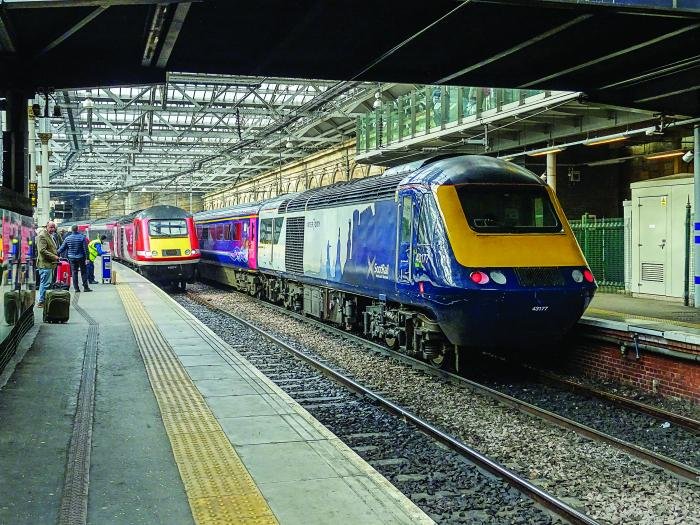 LNER HST power car 43277 arrives at Edinburgh Waverley, bound for London King's Cross as Scotrail Inter7City liveried power car 43177 rests between duties in the adjacent Platform 20 on February 25 2019. Mark Chivers