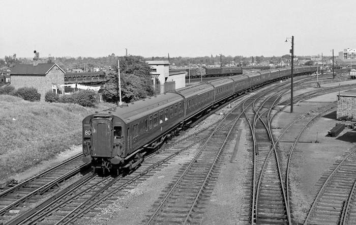 SR 4COR EMU leads a 4BUF and another 4COR on the 12.50pm Waterloo to Portsmouth Harbour service seen taking the Guildford line out of Woking on September 13, 1964.Photo:  Brian Stephenson