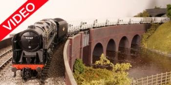 A Hornby 9F crosses Swithland Reservoir on the Hornby Magazine Great Central Railway 'OO' gauge layout.